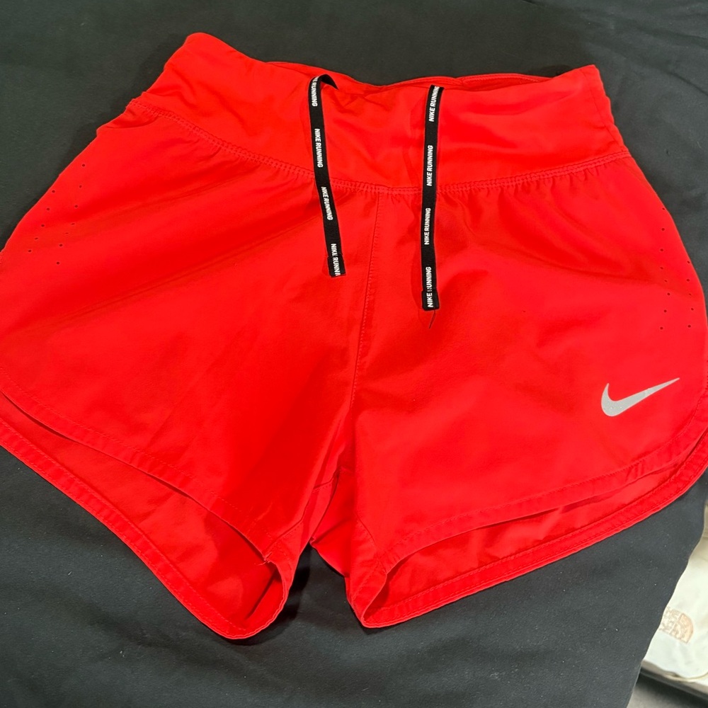 Bright red/orange Nike running shorts
